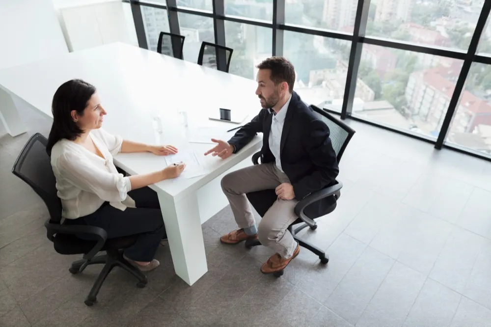 Tax preparer meeting with a client at a conference table