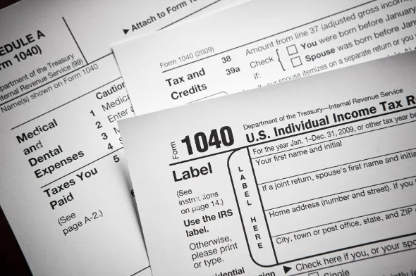 Stack of IRS 1040 tax forms